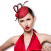 An elegant woman in red dress weariing a red sinamay button cocktail hat with satin ribbon in heart-shaped (decorated with 4 pieces of zicrons), a red arrow feather and red pom pom