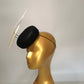 black sinamay pillbox hat with 2 floating feathers on mannequin head