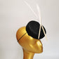 black sinamay pillbox hat with 2 floating feathers on mannequin head