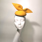 yellow wool felt cocktail hat for women on mannequin head